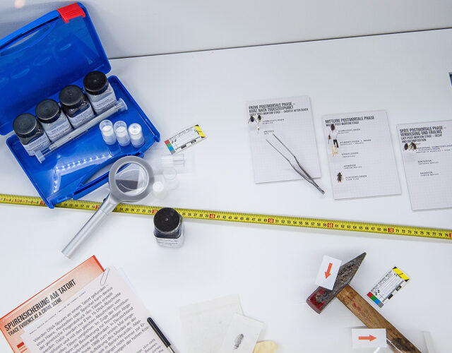 Overhead view of DNA evidence kit on white background.