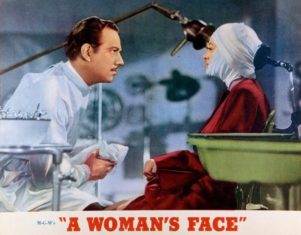 Movie poster with a colorized still of a doctor and woman with bandages around her head and face