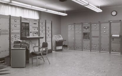 black and white photo of an early computer room