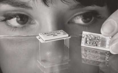 women looking closely at a computer chip