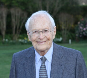 Rosenkranz in a suit and tie, smiling