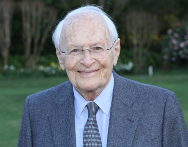 Rosenkranz in a suit and tie, smiling