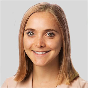 Caroline Hopkins in peach-colored shirt, smiling