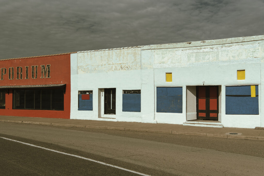 Streetview of colorfully painted, empty-looking commercial buildings