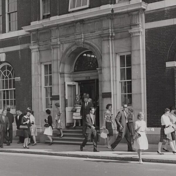 A black and white photo from 1965 of Rohm and Haas employees leaving the company's Philadelphia office