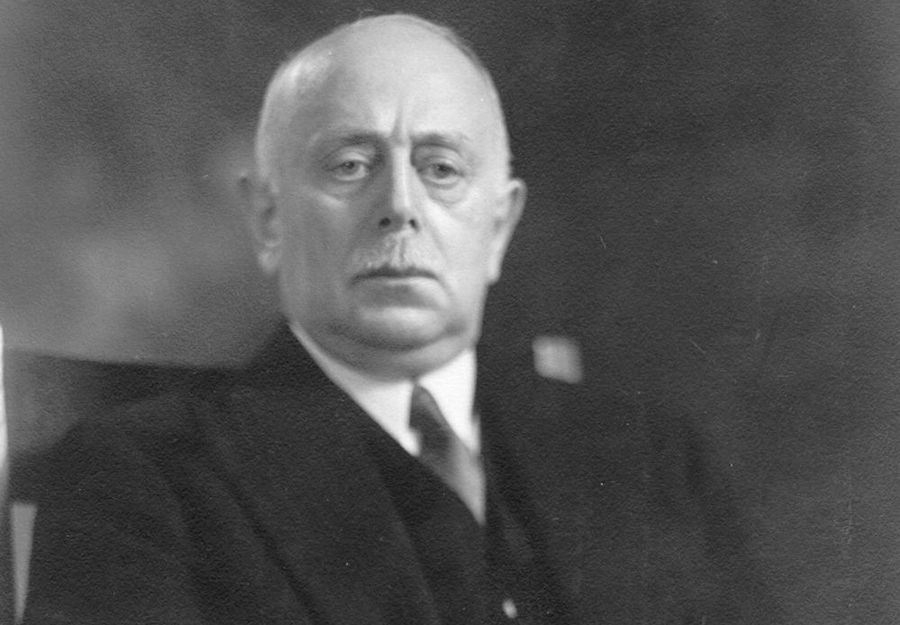 black and white photograph of a man in a suit and tie seated