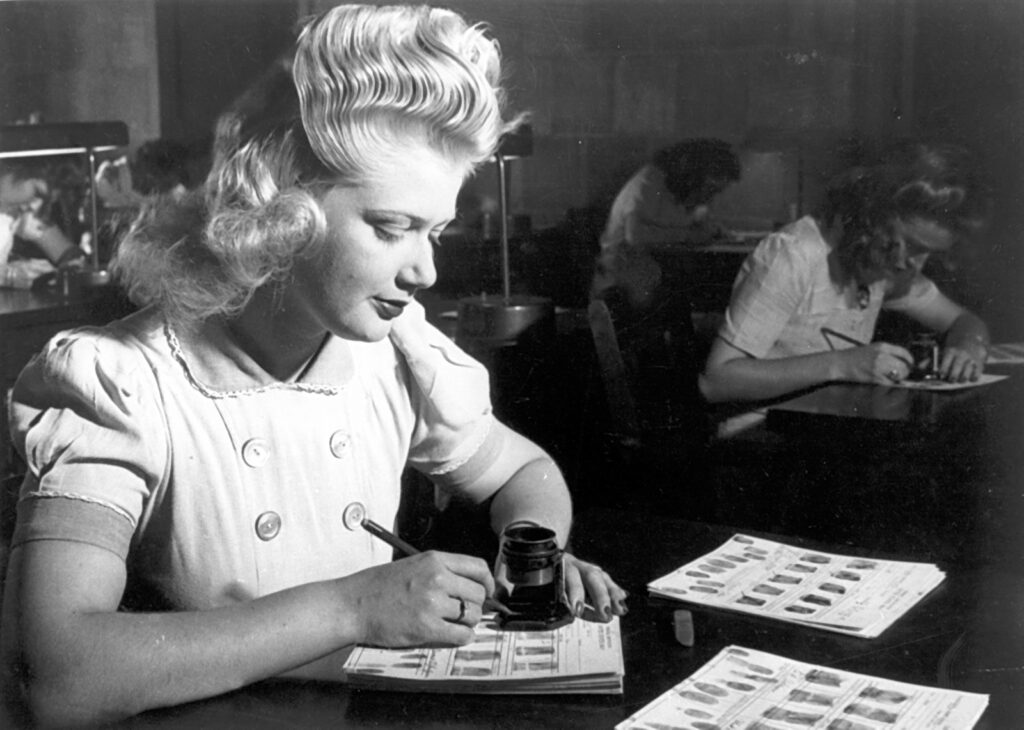 Black and white photo of women working at desks