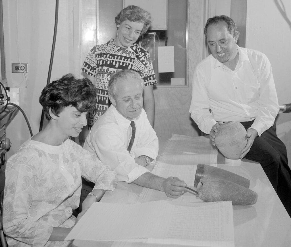 Black and white photo of four people in a room