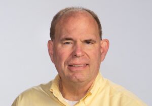 Hugh Slotten in yellow collared shirt