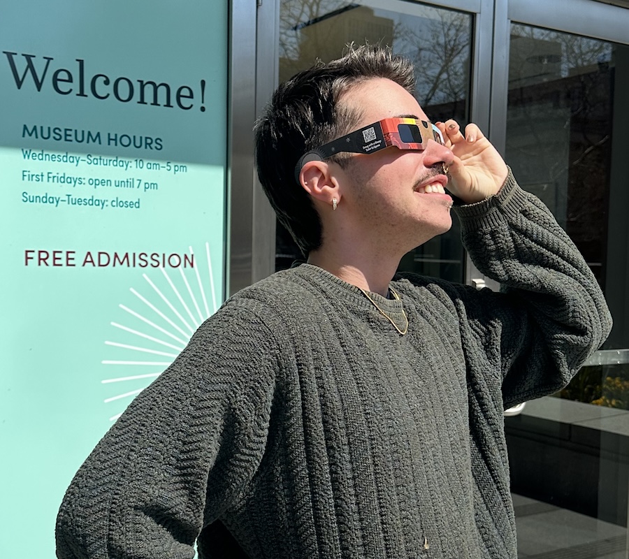 person looking at the sun with eclipse glasses on