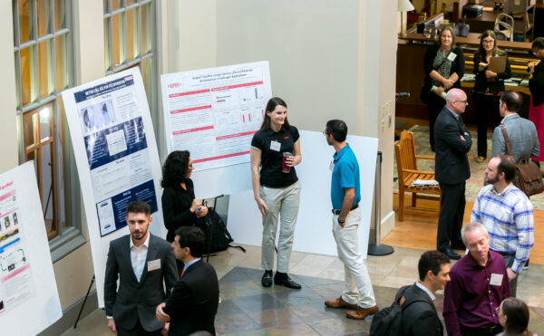 conversation near posters on easels