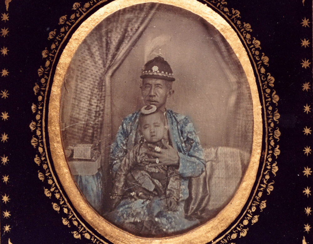 Daguerreotype of old man in royal clothing with infant child