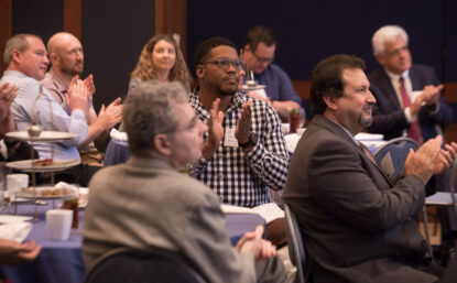 Innovation Day attendees applauding Moore Medalist Kevin Maloney