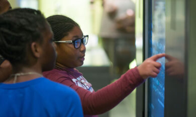 two children pointing at museum display