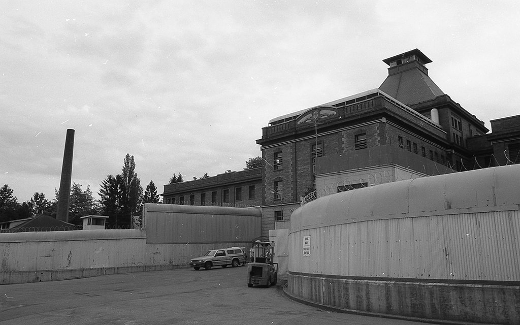 Black and white photograph of a large, brick and concrete institutional building