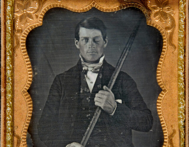 A portrait of Phineas Gage holding a piece of iron.