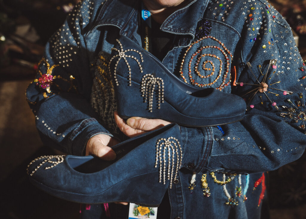 Close up of bedazzled women's shoes in someone's hands