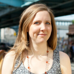 Samantha Wittchen outdoors in sequin tank top and orange/clear beaded necklace