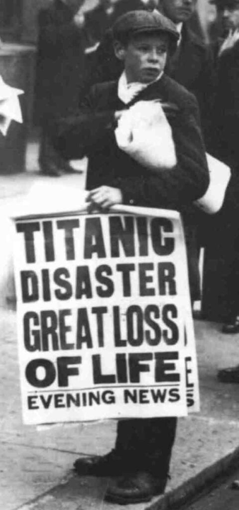 black and white photo of boy selling papers