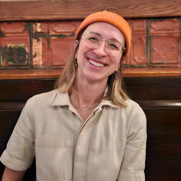 headshot of a woman in an orange cap